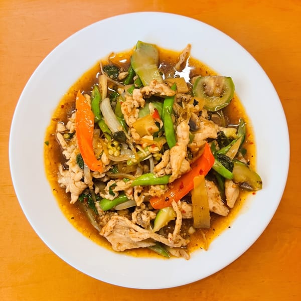 Spicy stir-fried chicken with green beans, bell peppers, and eggplant in a rich sauce.